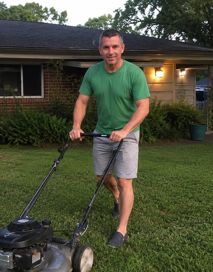 Jack, founder of Lawn Expert Jack, mowing his front lawn